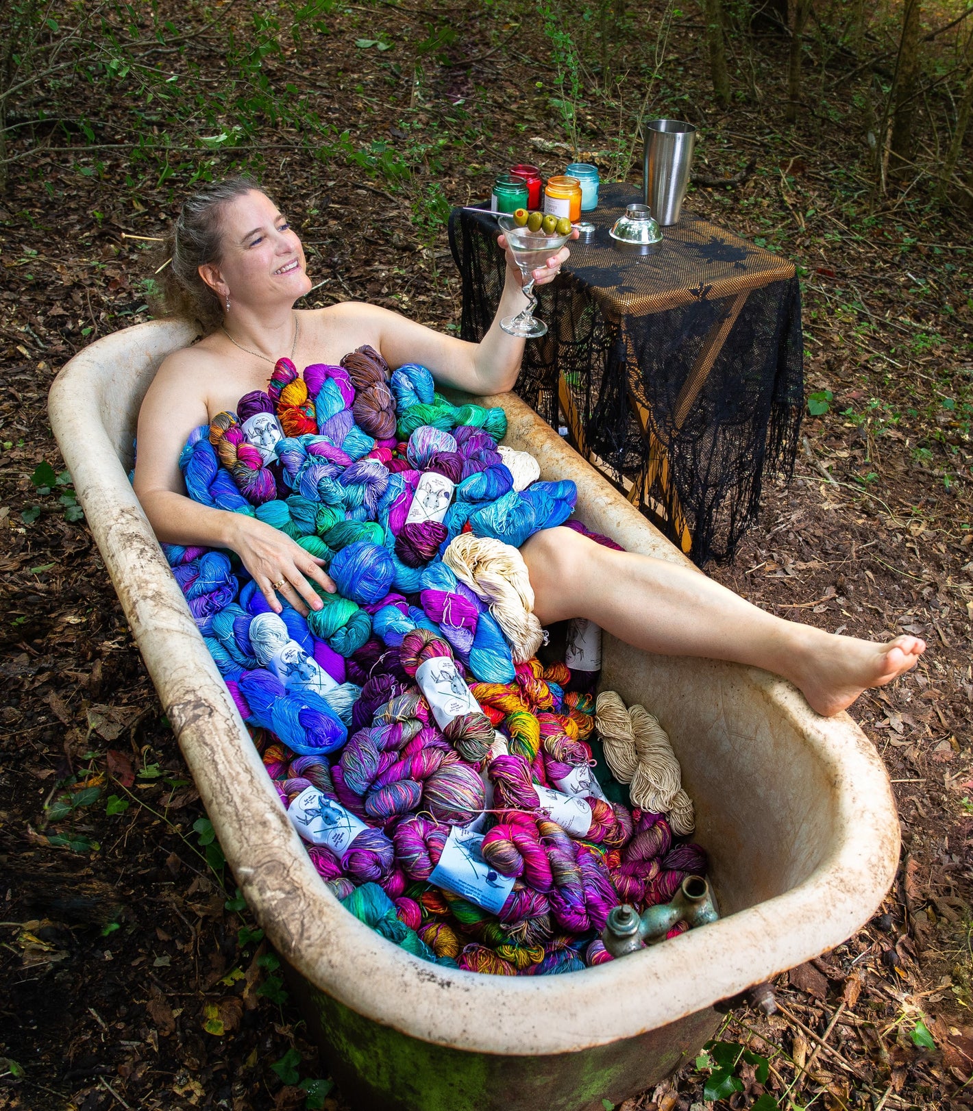 Woman in bathtub full of yarn